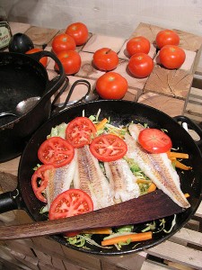 fish and tomatoes in fry pan