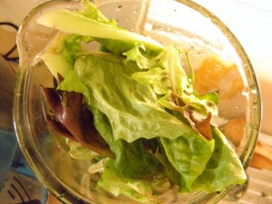 blender jug filled with lettuce leaves