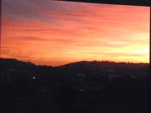 pink, orange sunrise on coast hill silhouette